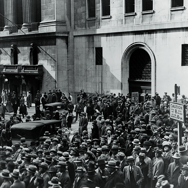 A crowd of people gather outside the New York Stock Exchange following the Crash of 1929, the most devastating stock market crash in the history of the United States