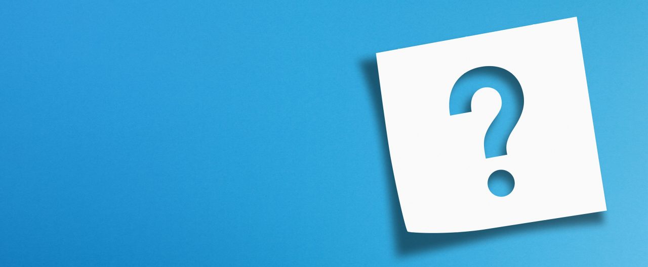 Question mark shape cut out in a white post-it-note on a blue gradient background