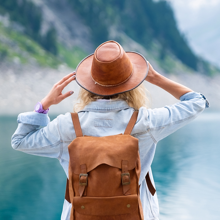 Woman overlooking water and mountains 