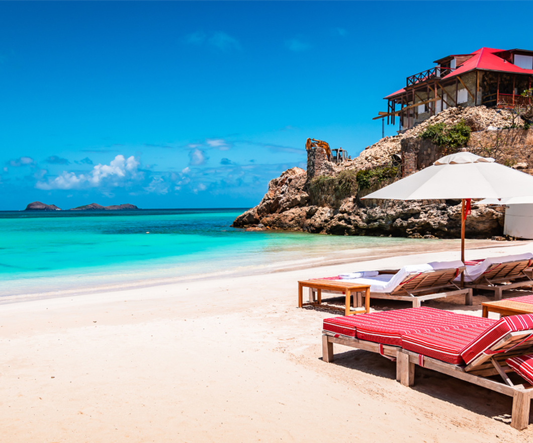 Luxury beach chairs and umbrella on exotic beach in St Barths, Caribbean Island