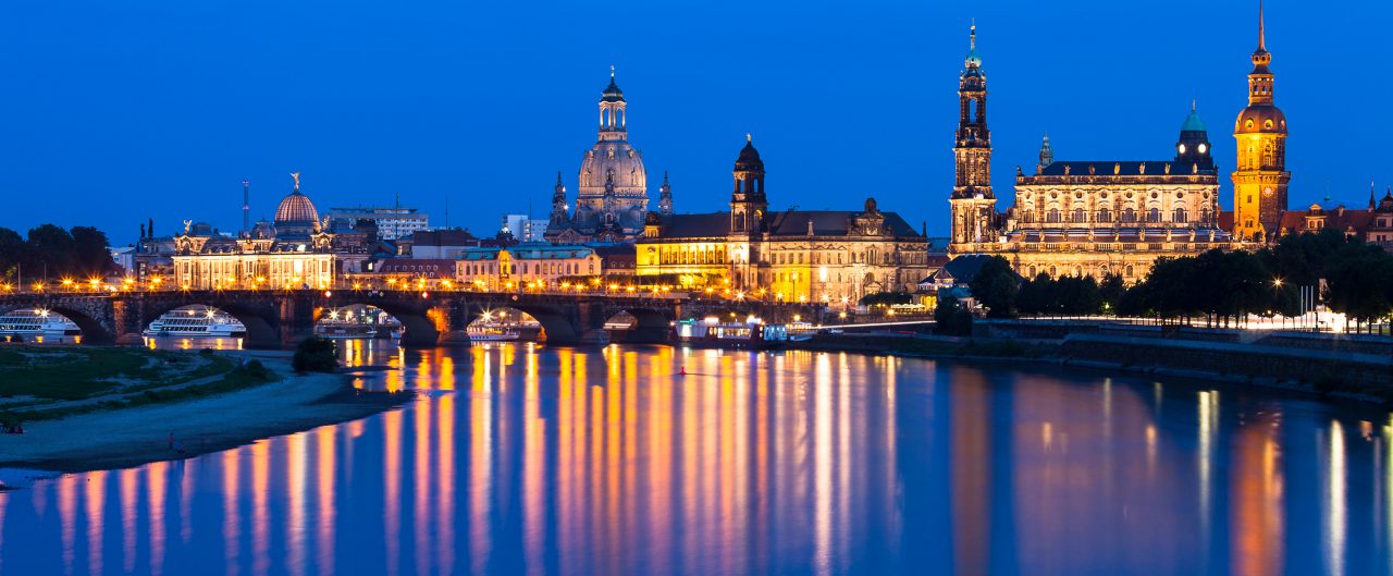 Dresden old town skyline along the Elbe river with reflection during evening twilight. Germany.