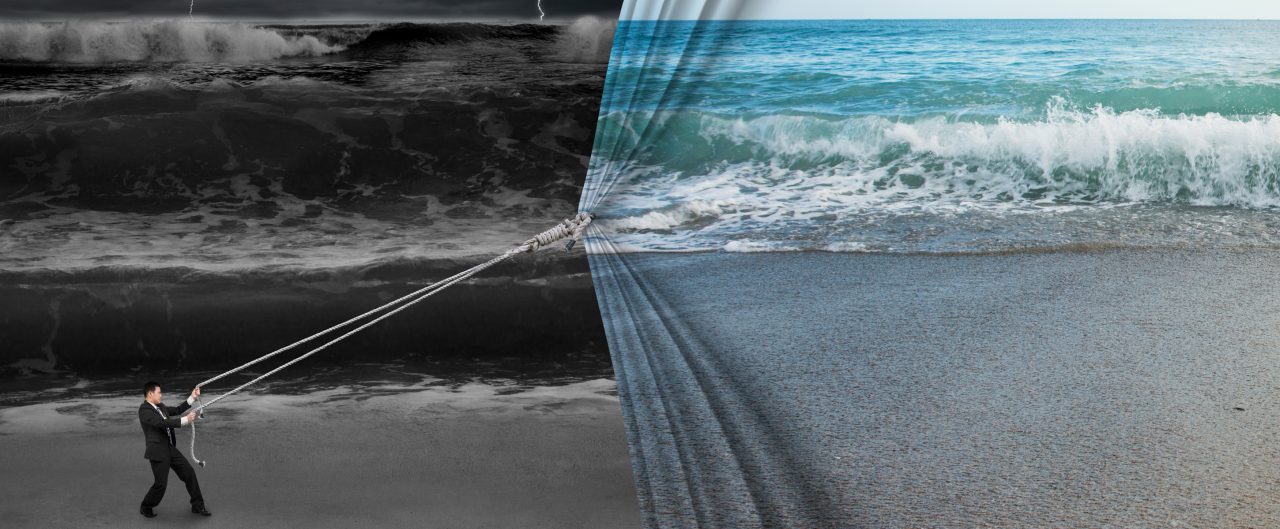 businessman pulling open calm sea curtain covered dark stormy ocean background