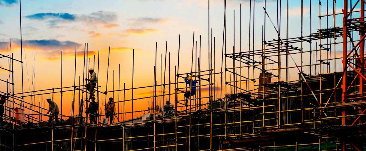 Workers climbing scaffolding on construction site
