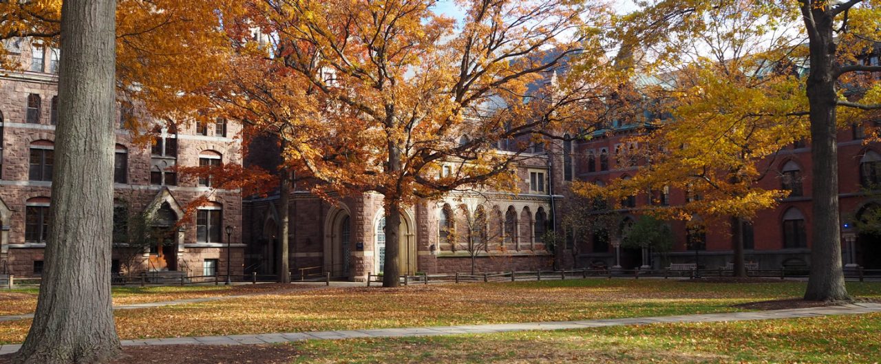 College campus in the fall with an inset photo of Barry Mills