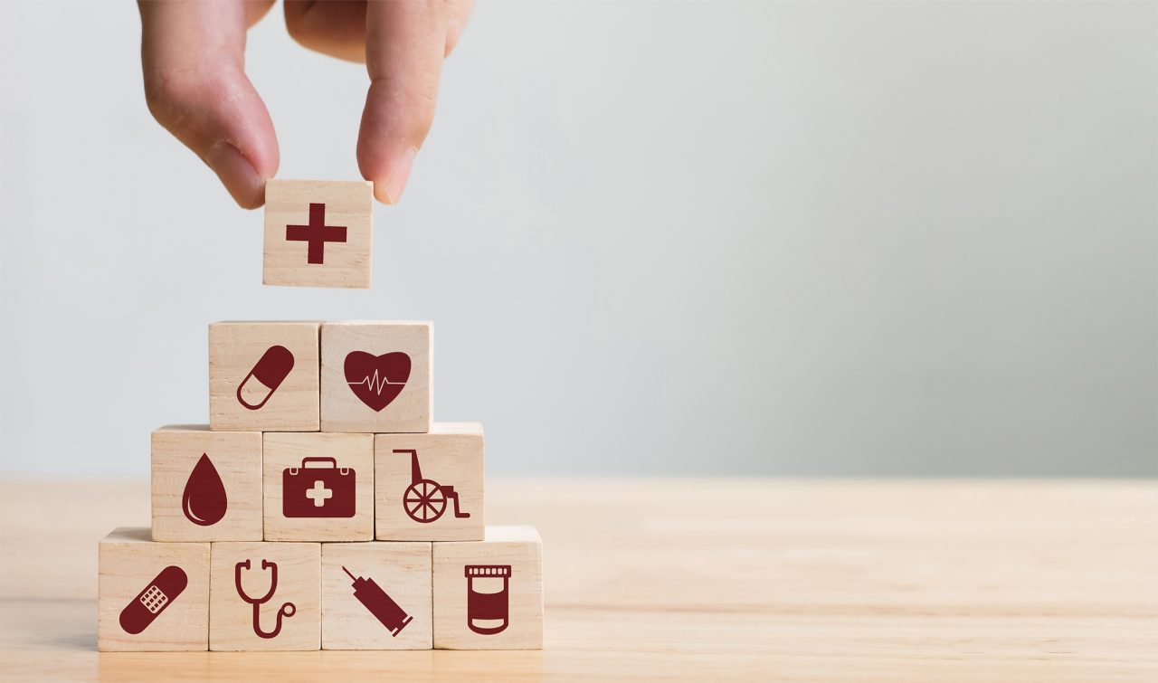 Wooden toy block pyramid with healthcare symbols on each block
