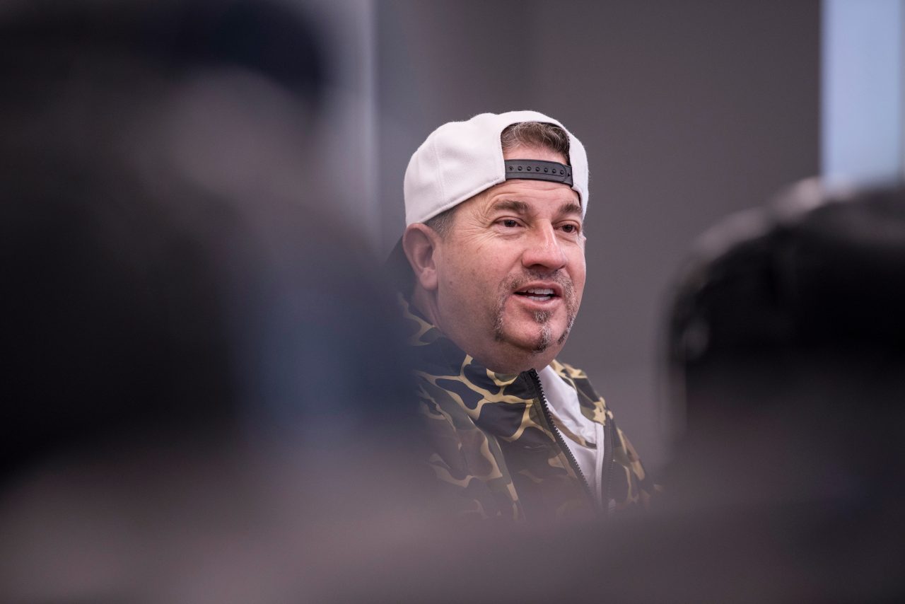 A man with a backwards baseball cap 