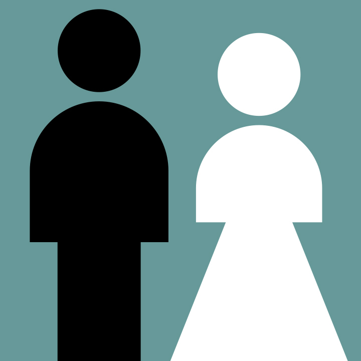 Photo of adult woman walking in nature and holding hands with two children.