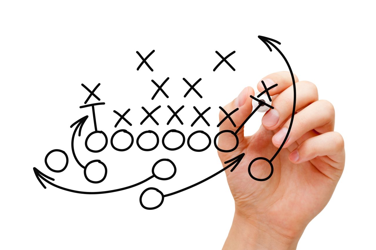 Hand drawing American football strategy with black marker