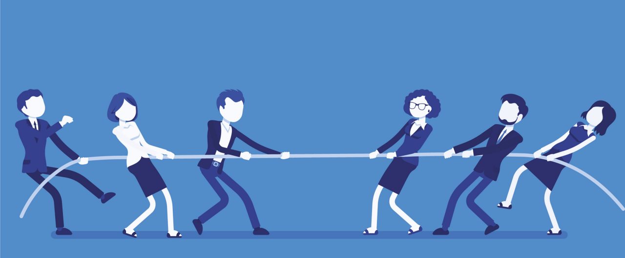 Business men and women playing tug of war