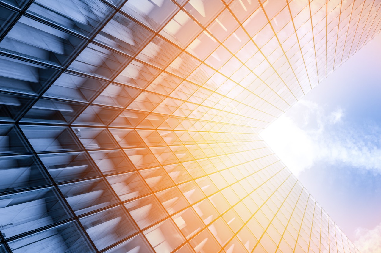 Upward view of a skyscraper with sunlight