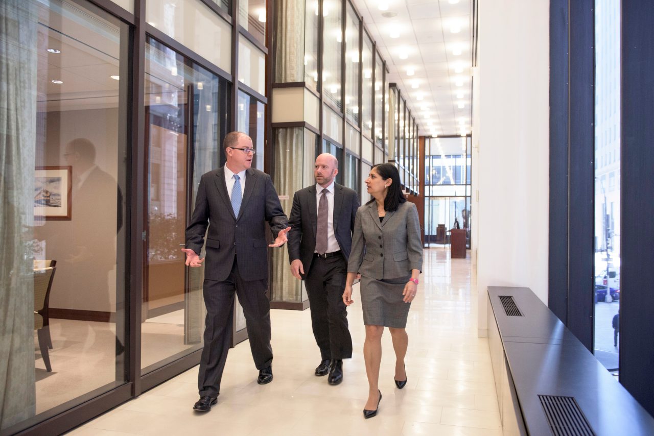 3 BBH'ers Walking down the hallway of an office building