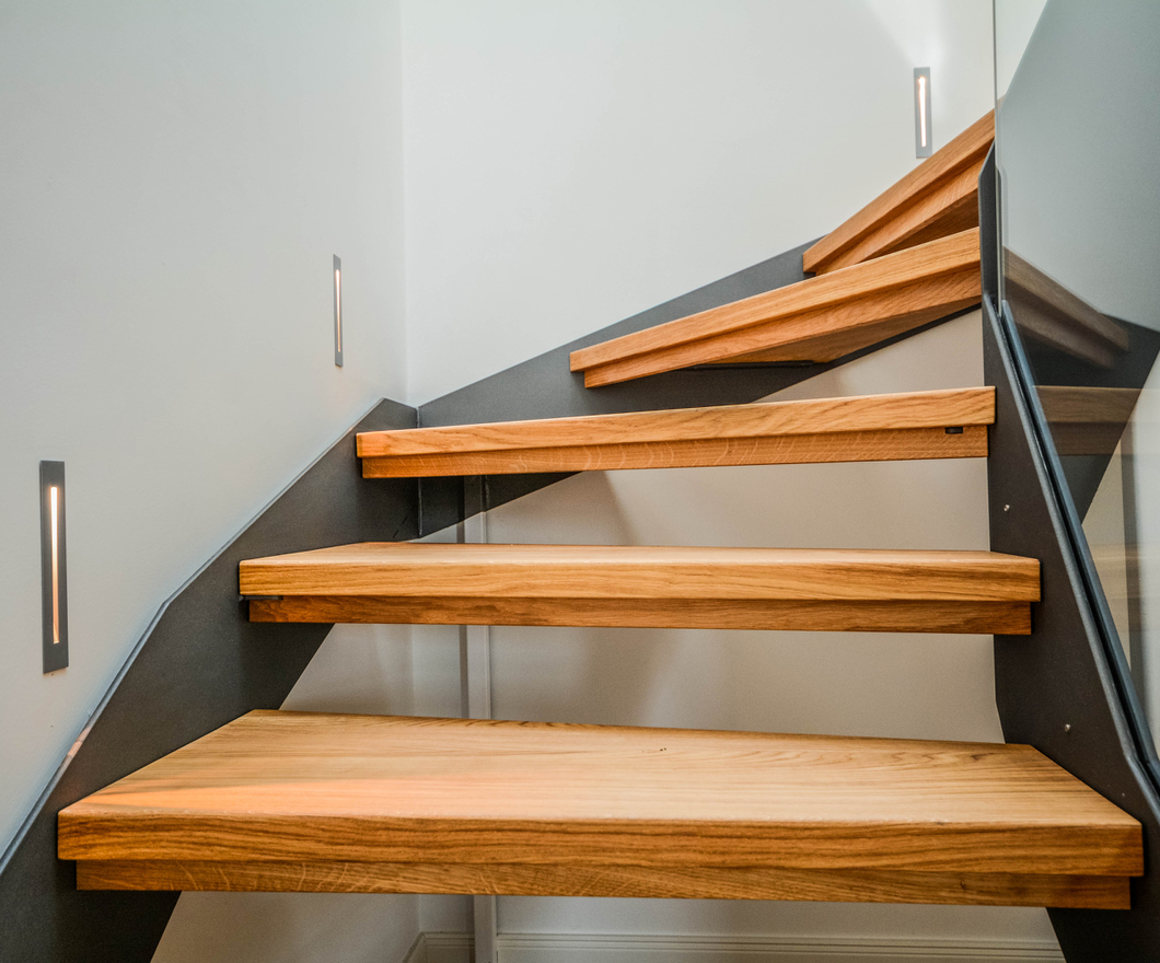Modern steel staircase with wooden steps winding up