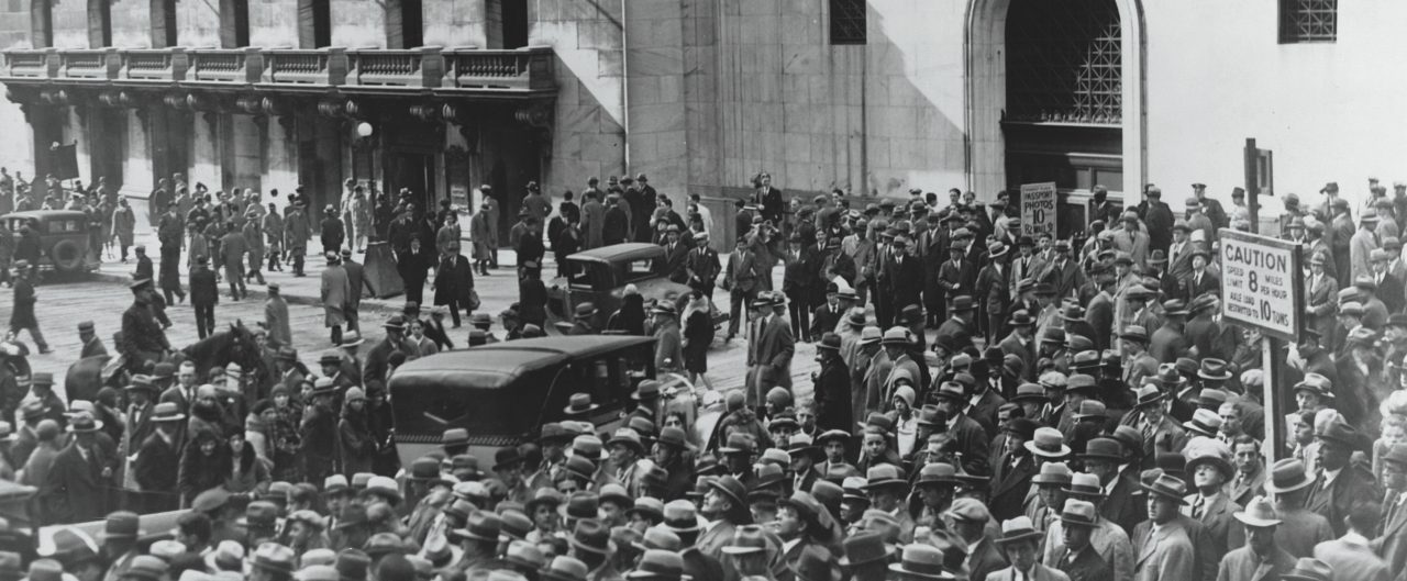 A crowd of people gather outside the New York Stock Exchange following the Crash of 1929, the most devastating stock market crash in the history of the United States