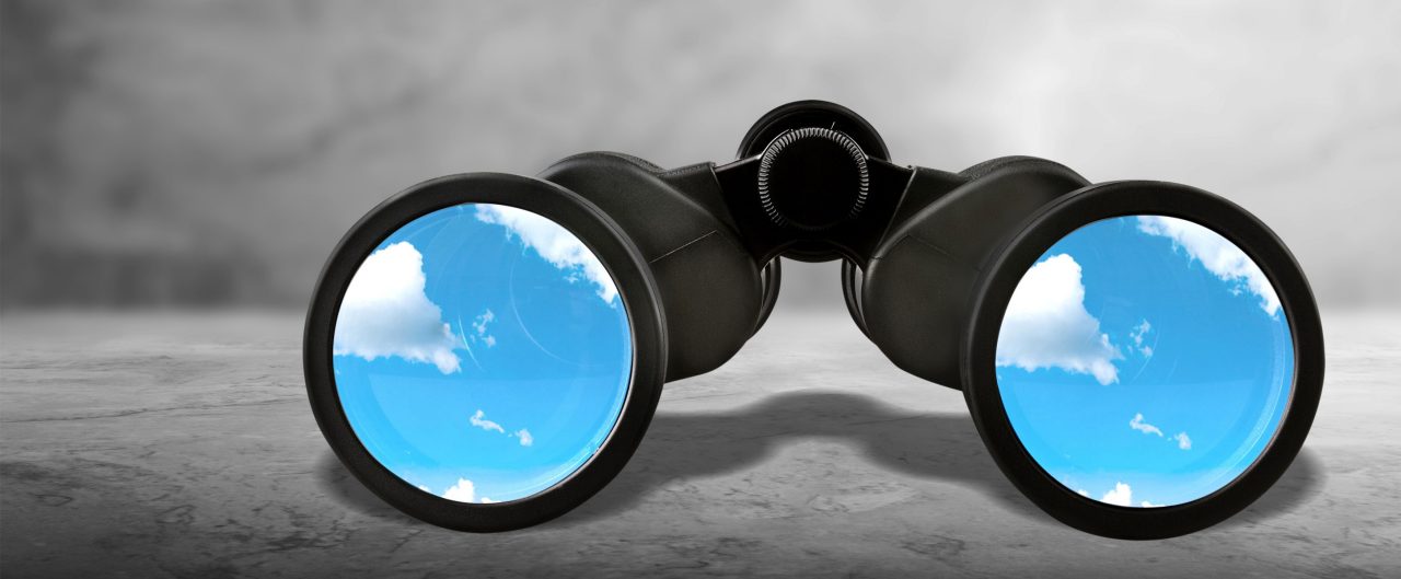 Close up of black binocular with sky in glasses isolated on white