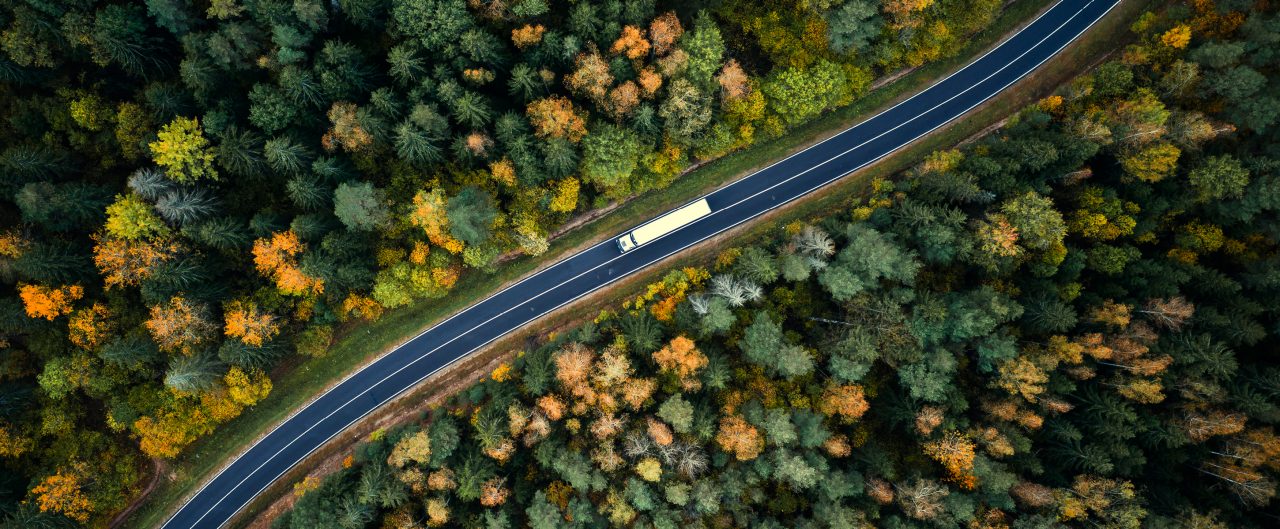 Aerial view of heavy truck on a narrow twisting road