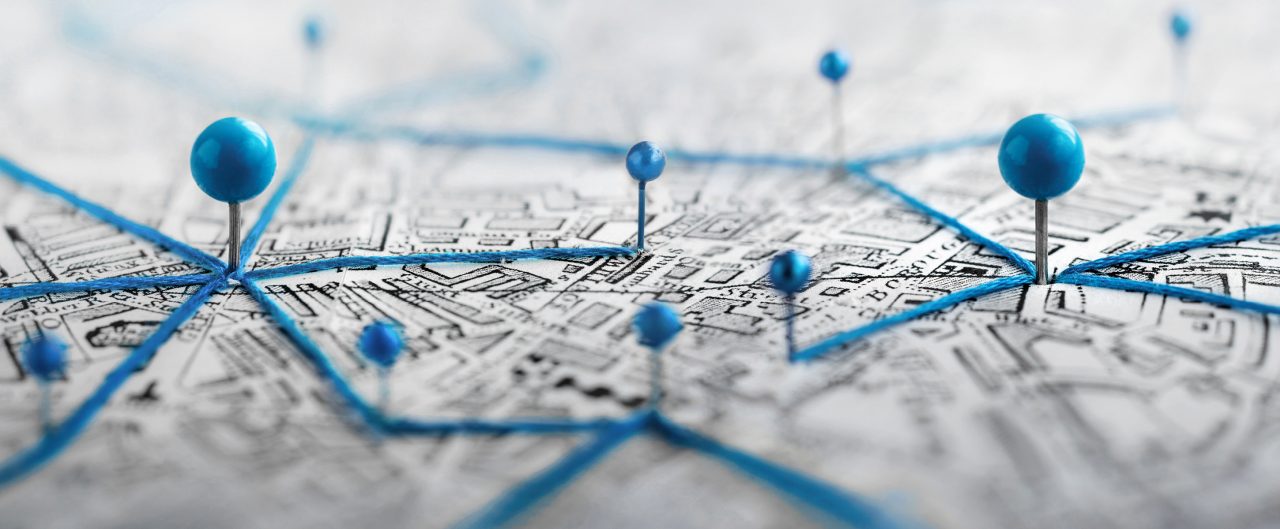 Location marking with a pin on a map with routes