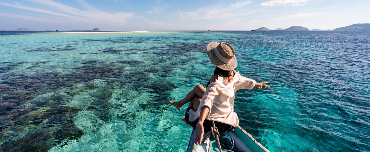 Woman sitting on a canoe overlooking the water 