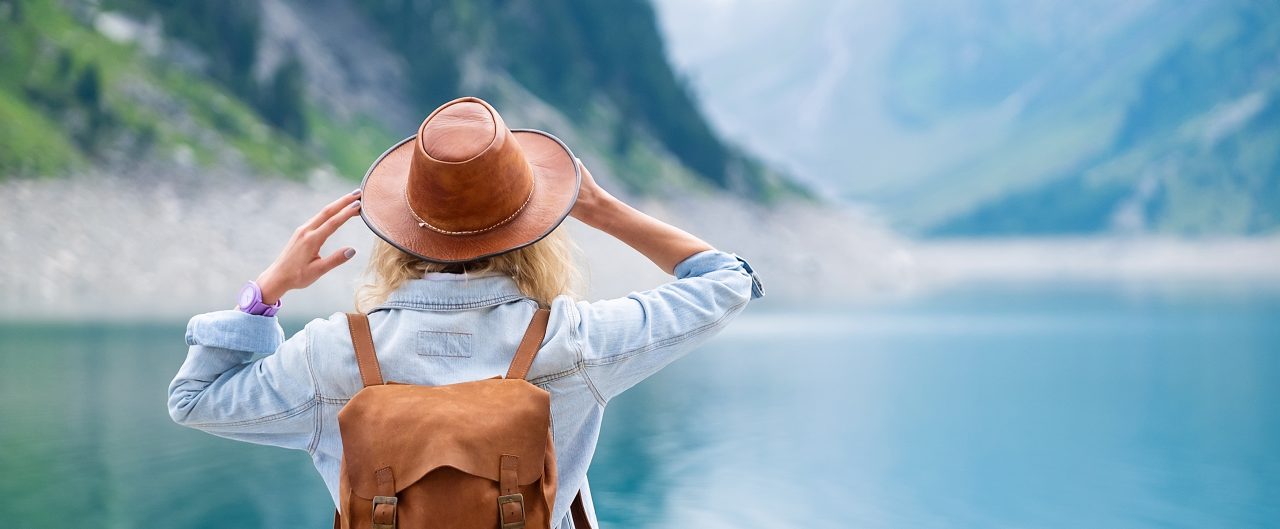 Woman overlooking water and mountains 