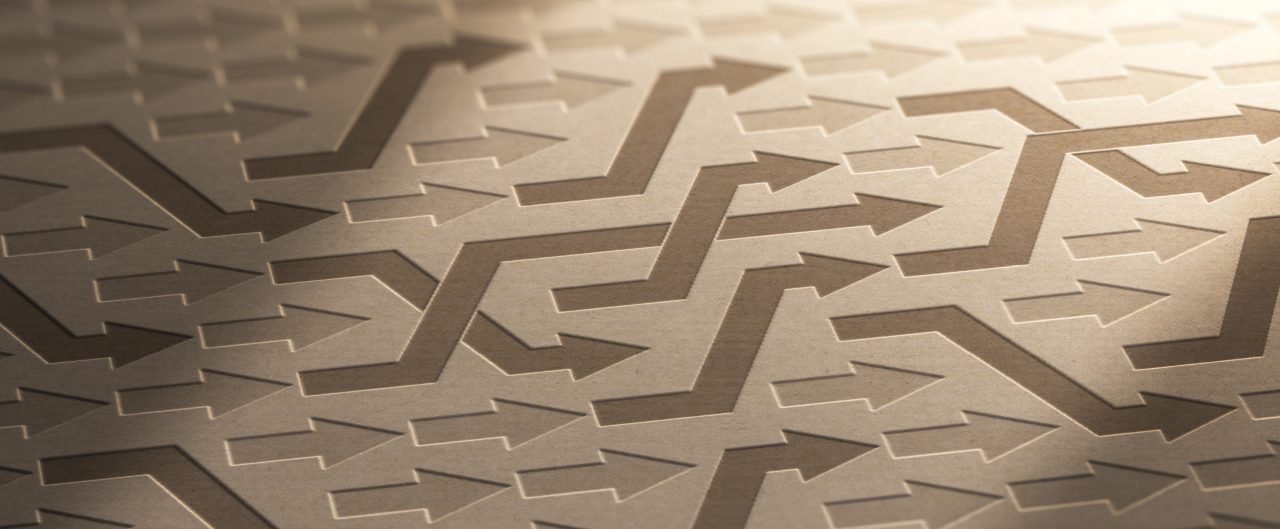 Illustration of many arrows changing way to converge toward objective on kraft paper