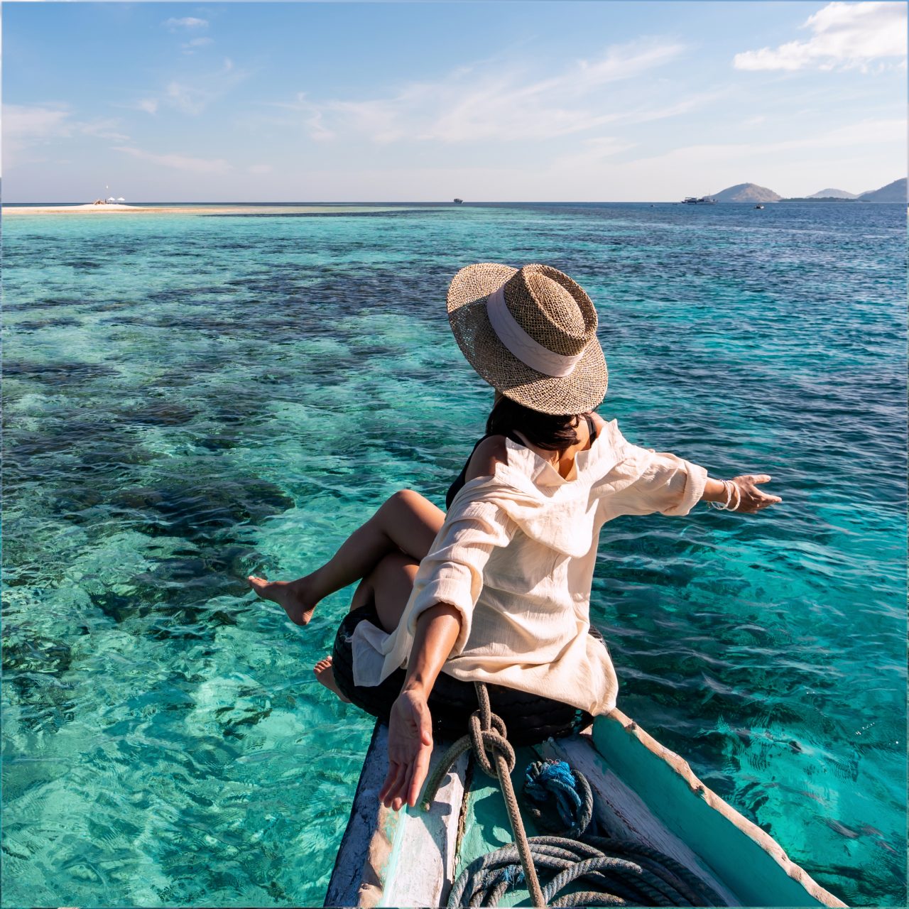 Woman sitting on a canoe overlooking water 
