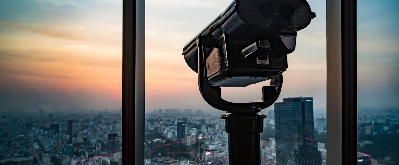Public binocular telescope binoscope, on top of observation deck looking at cityscape view