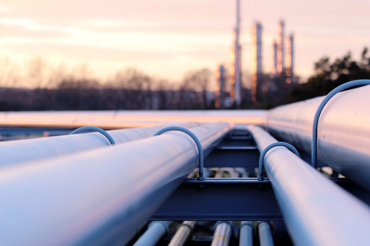 steel long pipe system in crude oil factory during sunset