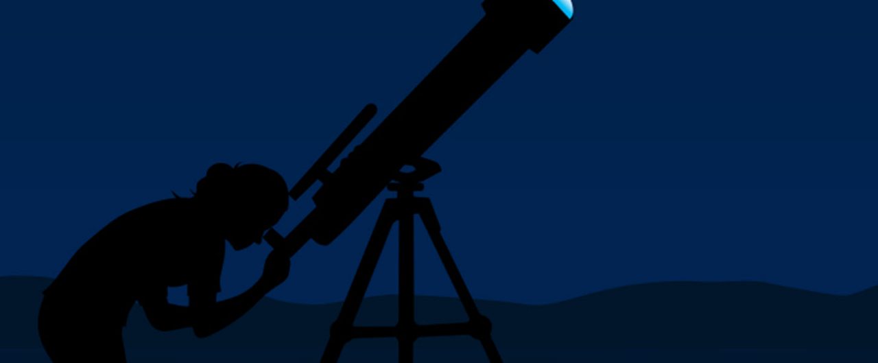 person looking through telescope at night 