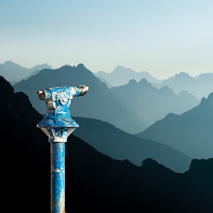 Public binoculars and mountain silhouettes at sunrise