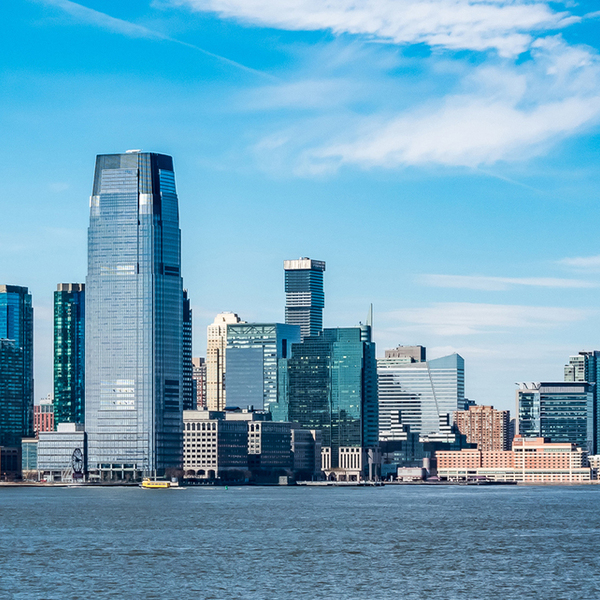 New Jersey city skyline seen past a large blue body of water