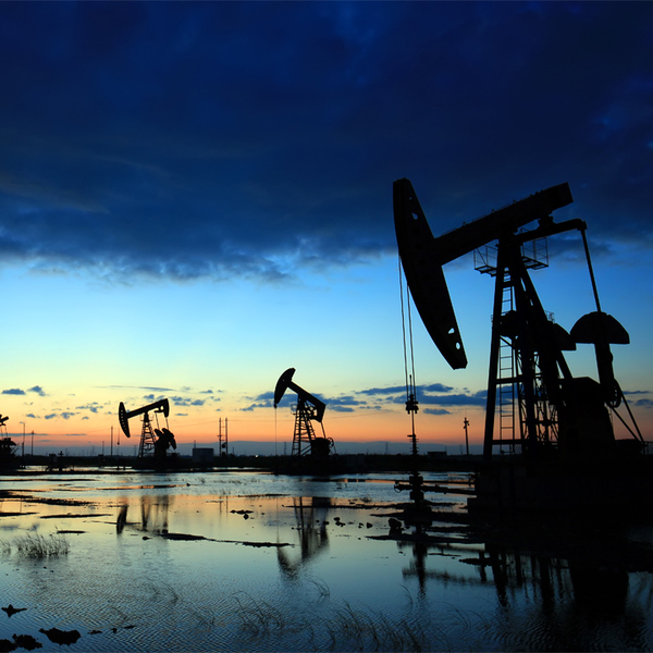 Silhouettes of Oil Pumps in Oil Field at Sunset