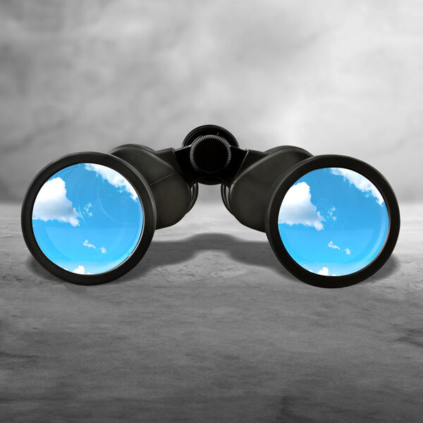 Close up of black binocular with sky in glasses isolated on white