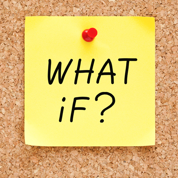 Yellow post-it-note pinned to a board with 'What if?' written on it
