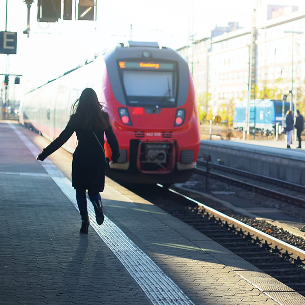 Woman running on platform to catch a train