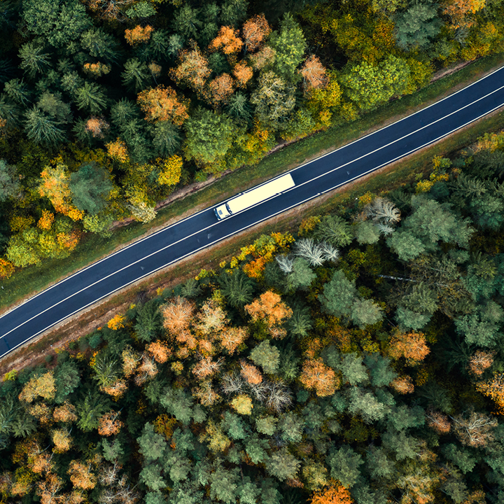 Aerial view of heavy truck on a narrow twisting road