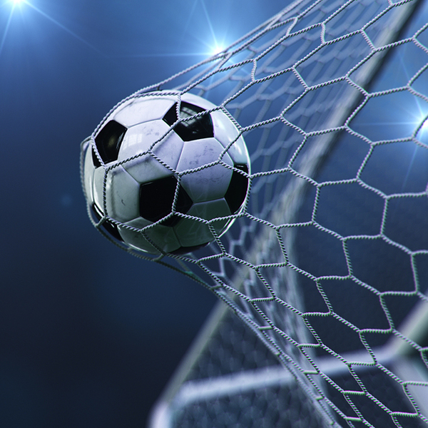 Football hitting the back of a goal net