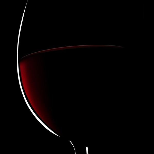 Glass of red wine against a dark background