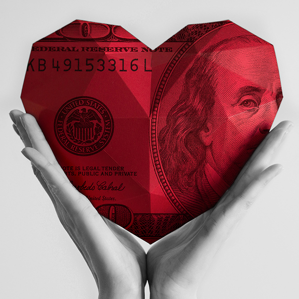Giant red heart of money held by hands