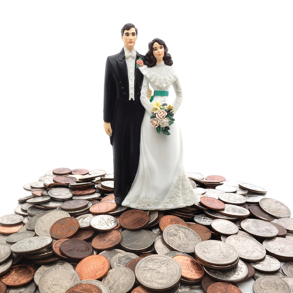 Plastic figures of a married couple, with a pile of coins behind them