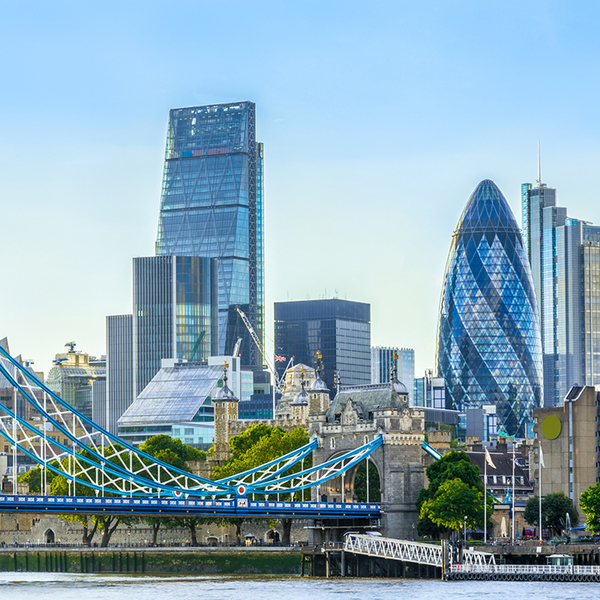 Tower bridge and financial district of London with a cloudless sky at sunset