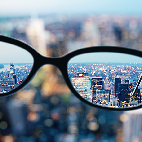 Close up of glasses on blurry city background. Clean vision concept. 3D Rendering