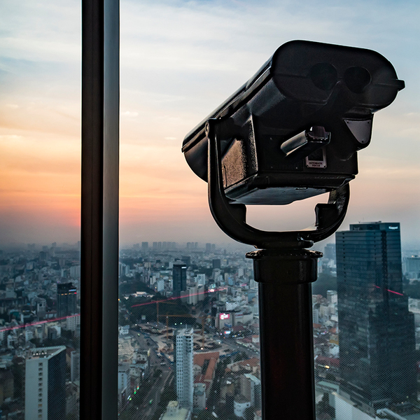 Public binocular telescope binoscope, on top of observation deck looking at cityscape view