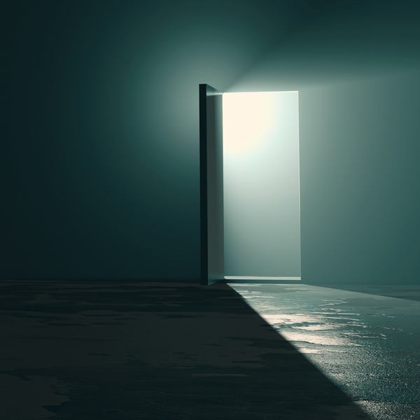 A bright exit door in dark room, the light at the end of the tunnel