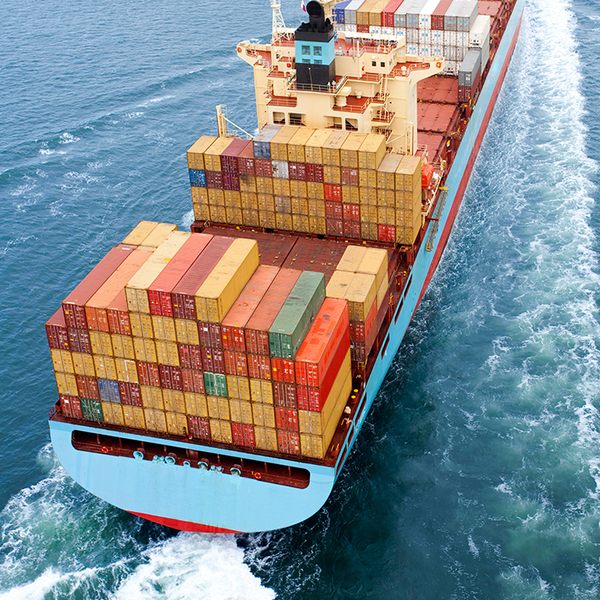 Close-up of a container ship carrying colorful shipments in the middle of the ocean