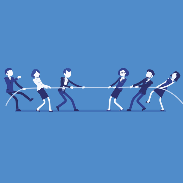 Business men and women playing tug of war