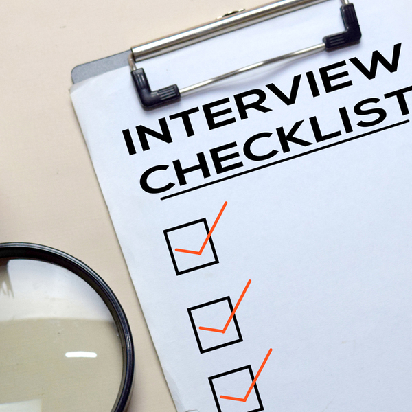 Interview Checlist write on a paperwork isolated on office desk.