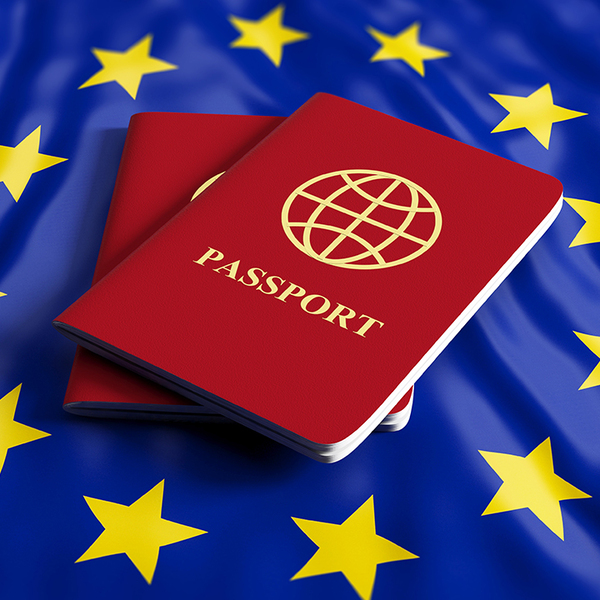 Two red passports in the center of the EU flag