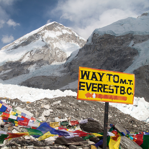 Signpost in the mountains pointing way to mount everest b.c., Khumbu glacier and prayer flags, Everest area, Nepal