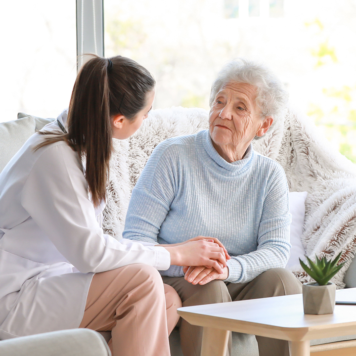 Doctor with senior woman in nursing home
