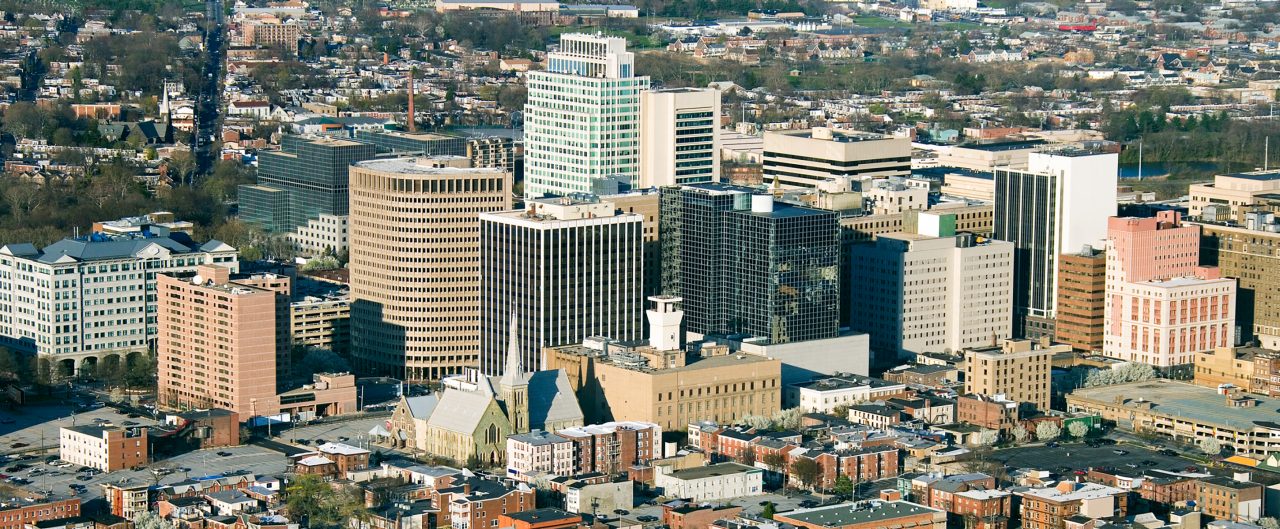 Wilmington, Delaware city aerial view with short brown town houses alongside skyscrapers