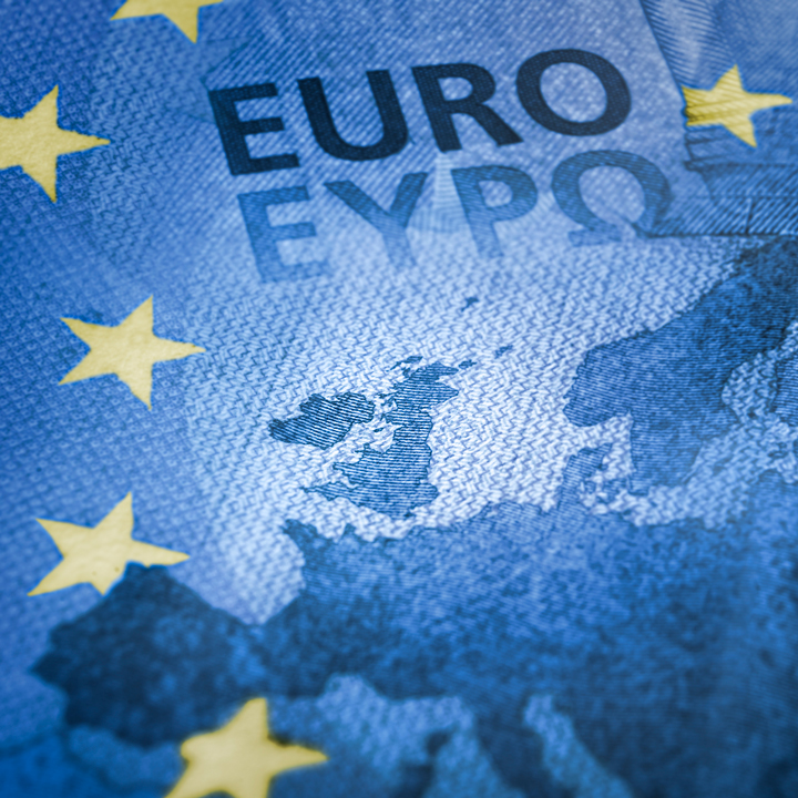 The E.U. flag, Euro bank-note, and map of Britain overlapping each other to illustrate Brexit